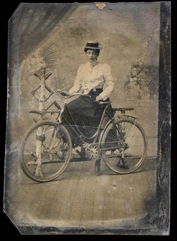 woman posing with bicycle.