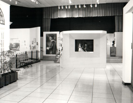 Photo of a museum exhibition shows a puppet stage with five marionettes on display.