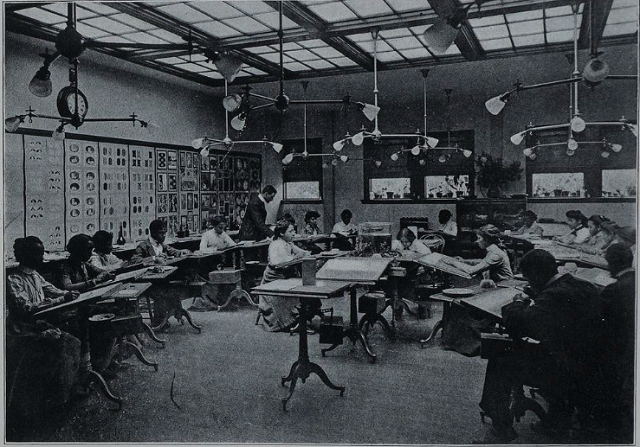 Photo of a classroom shows students drawing at desks