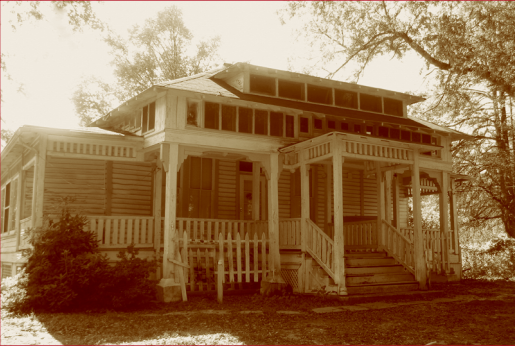 Photo of bungalow with two rows of small windows above the porch.