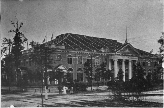 Photo of warehouse-sized, two-story building with ornate architectural trim