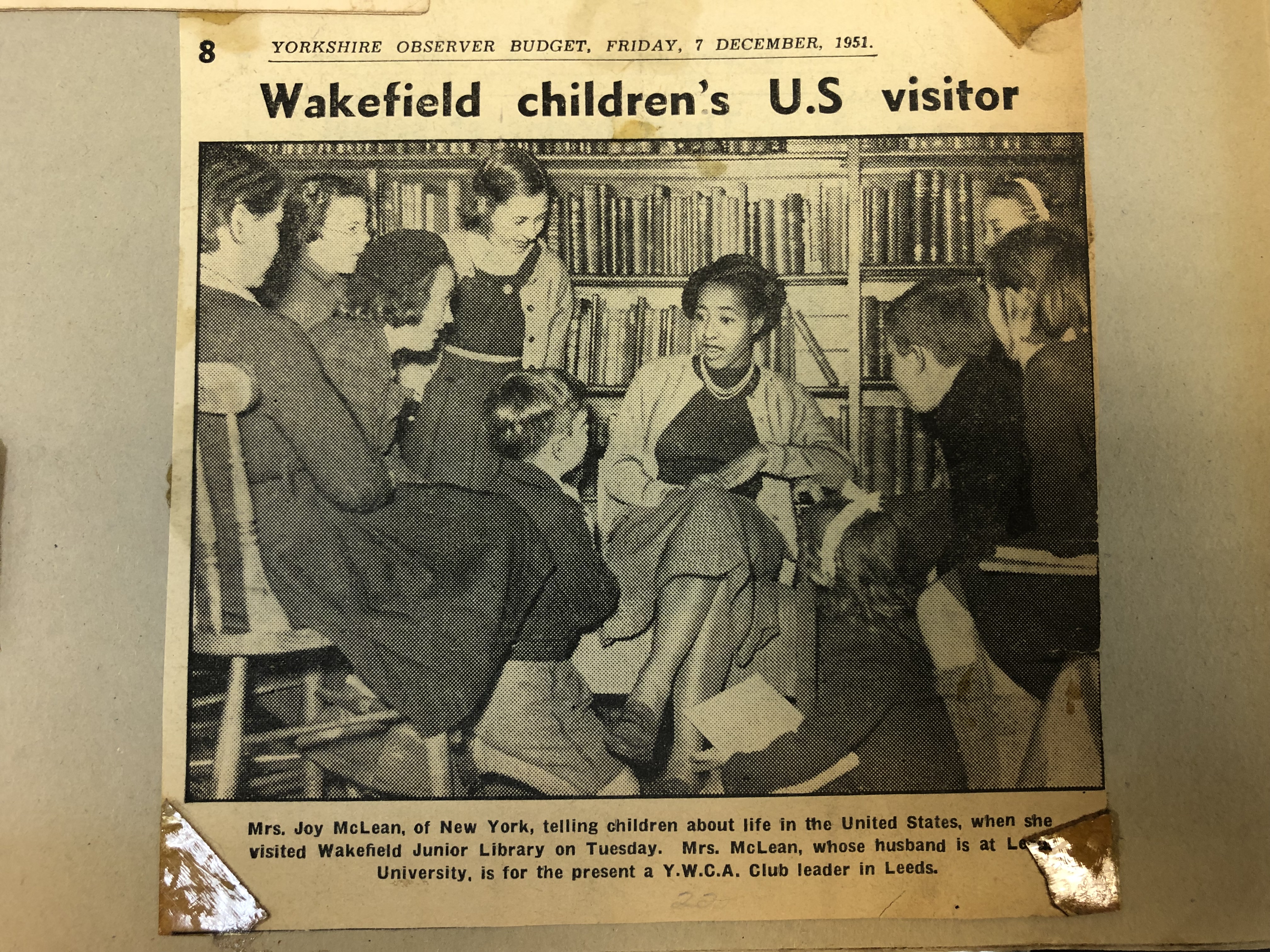 Joy McLean sits with children in the library