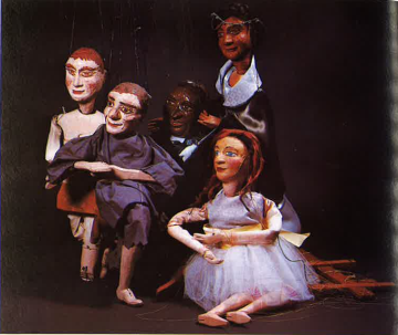 Color photo of five posed marionettes