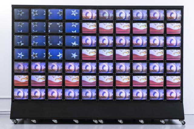 Wall of video monitors displaying video images that create an impression of the American flag