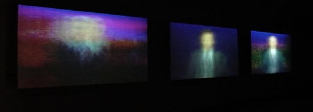 Installation view of artwork with blurred portrait renderings