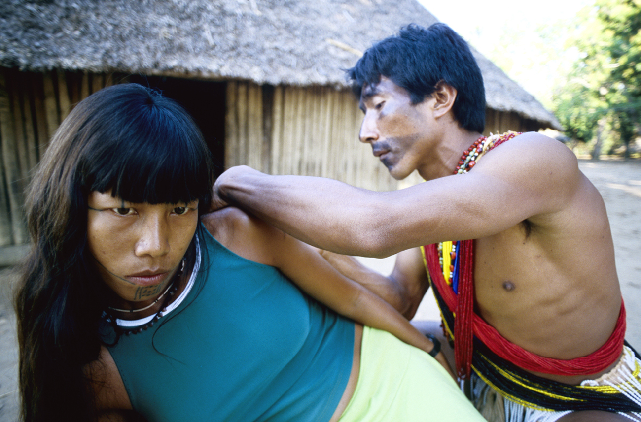 Jemy Kaiabi applying a name glyph tattoo on the arm of his client Silvana, Xingu National Park, Brazil. (Photo copyright © Lars Krutak)