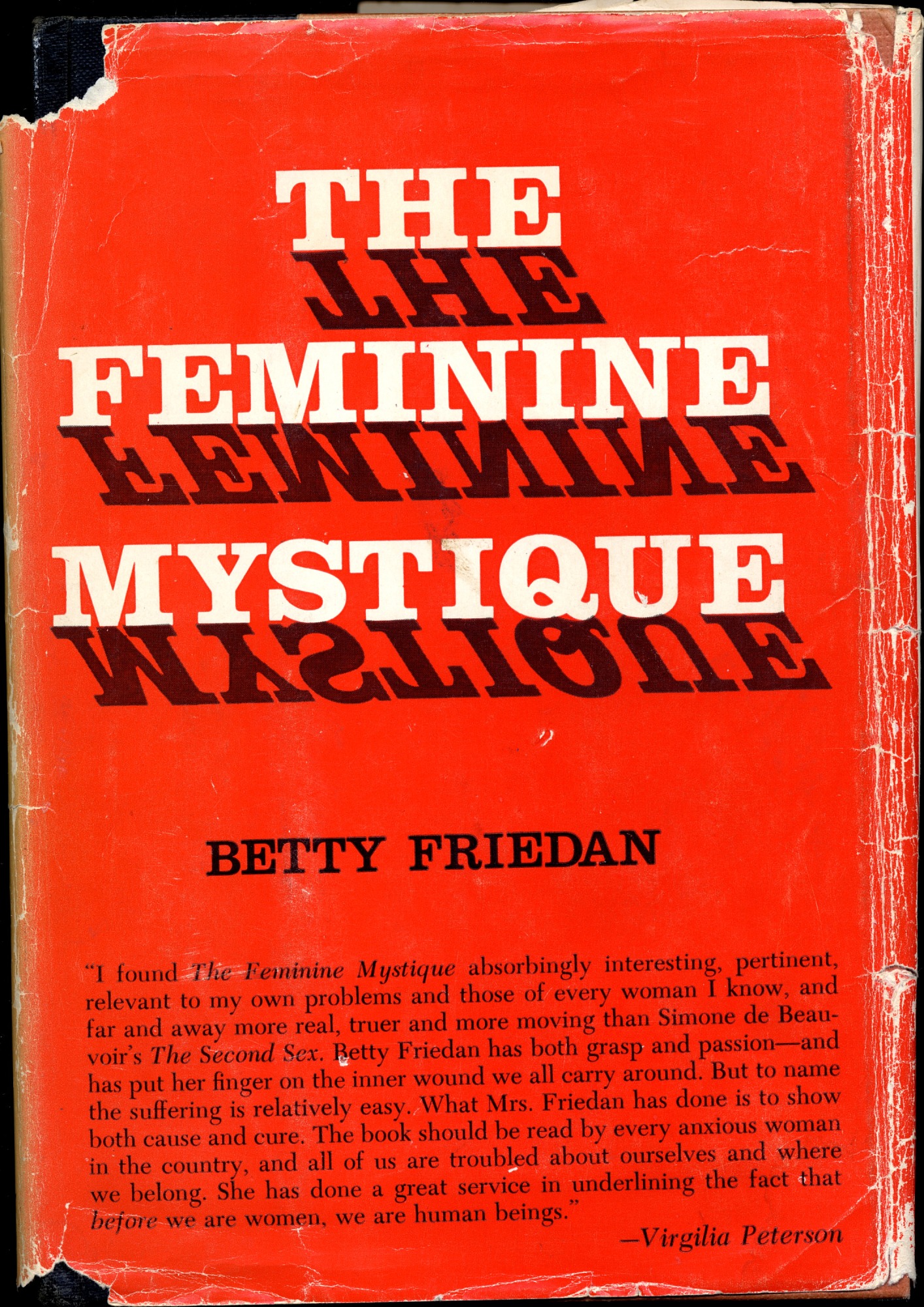 Red book cover for “The Feminine Mystique” by Betty Friedan.