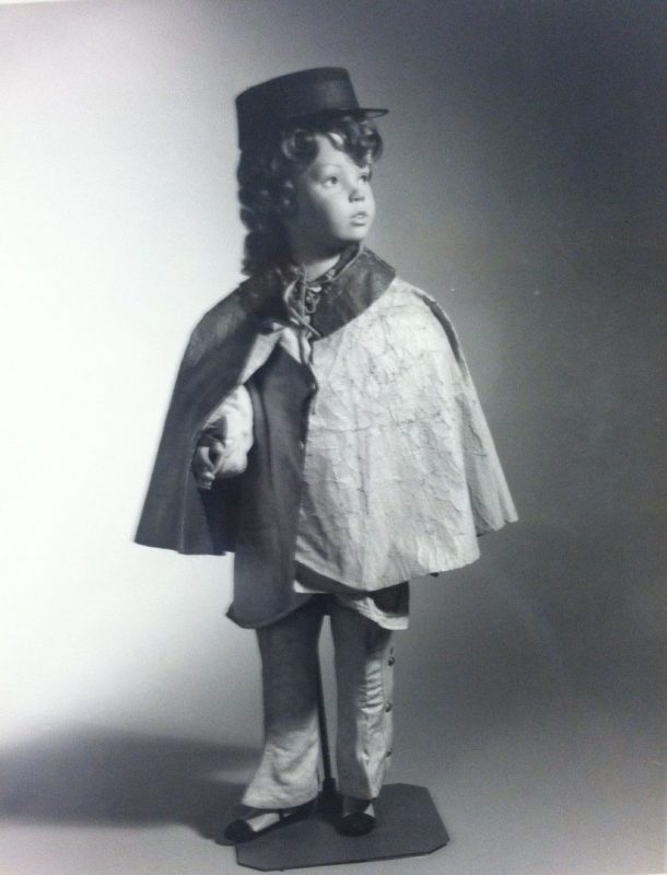 A cape staged on a child-sized mannequin