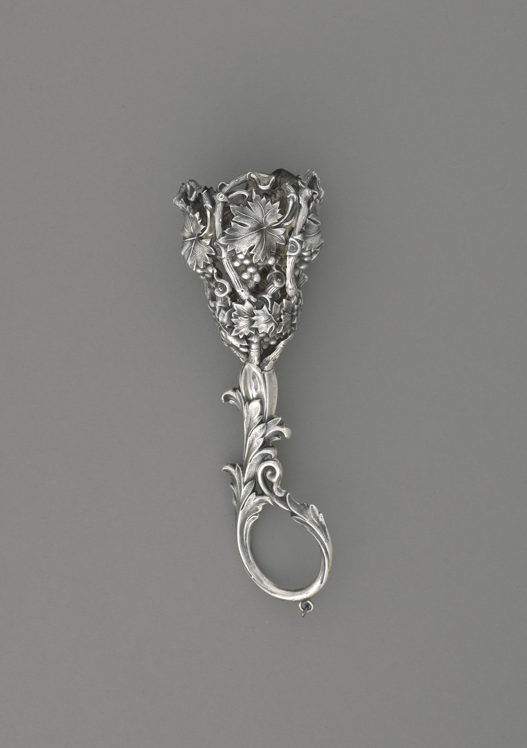 Silver bouquet holder with loop handle, stamped with a grape and leaf design 