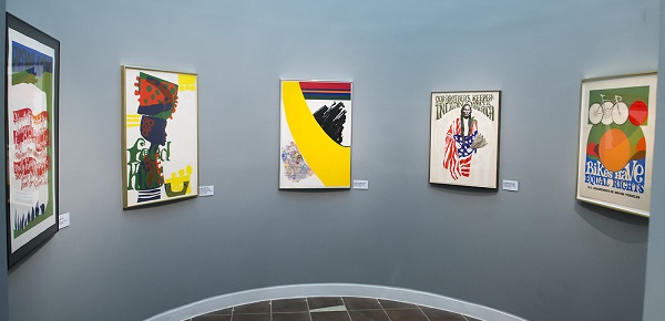 Five framed silkscreen prints hang on a gallery wall painted gray at the Anacostia Community Museum in 2015.