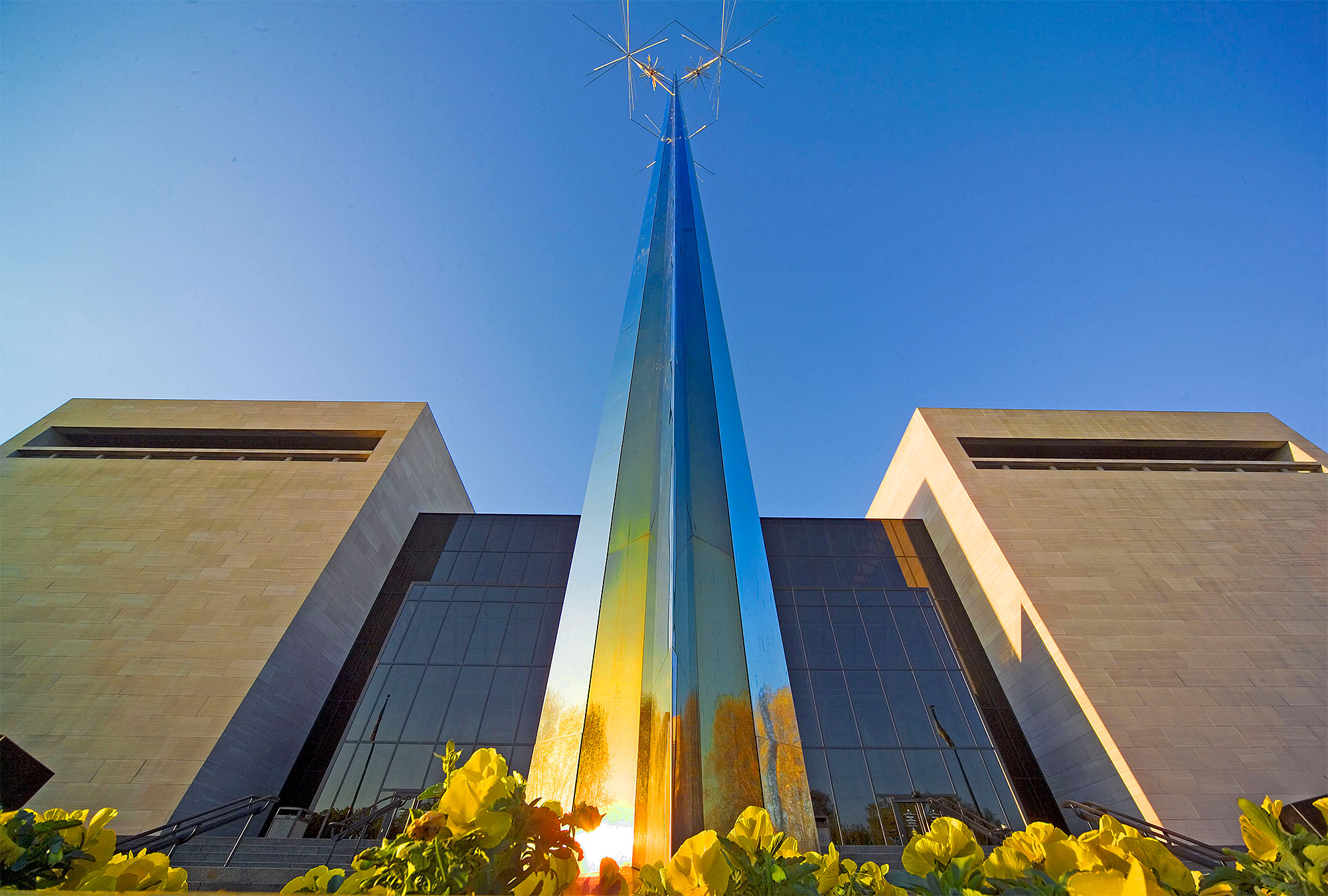 Sculptural glass spire in front of modern architectural features of National Air and Space Museum