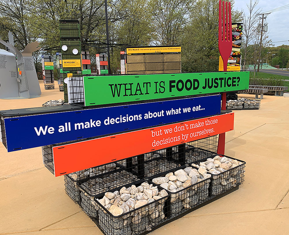 Outdoor sign display with text "What is food justice?"