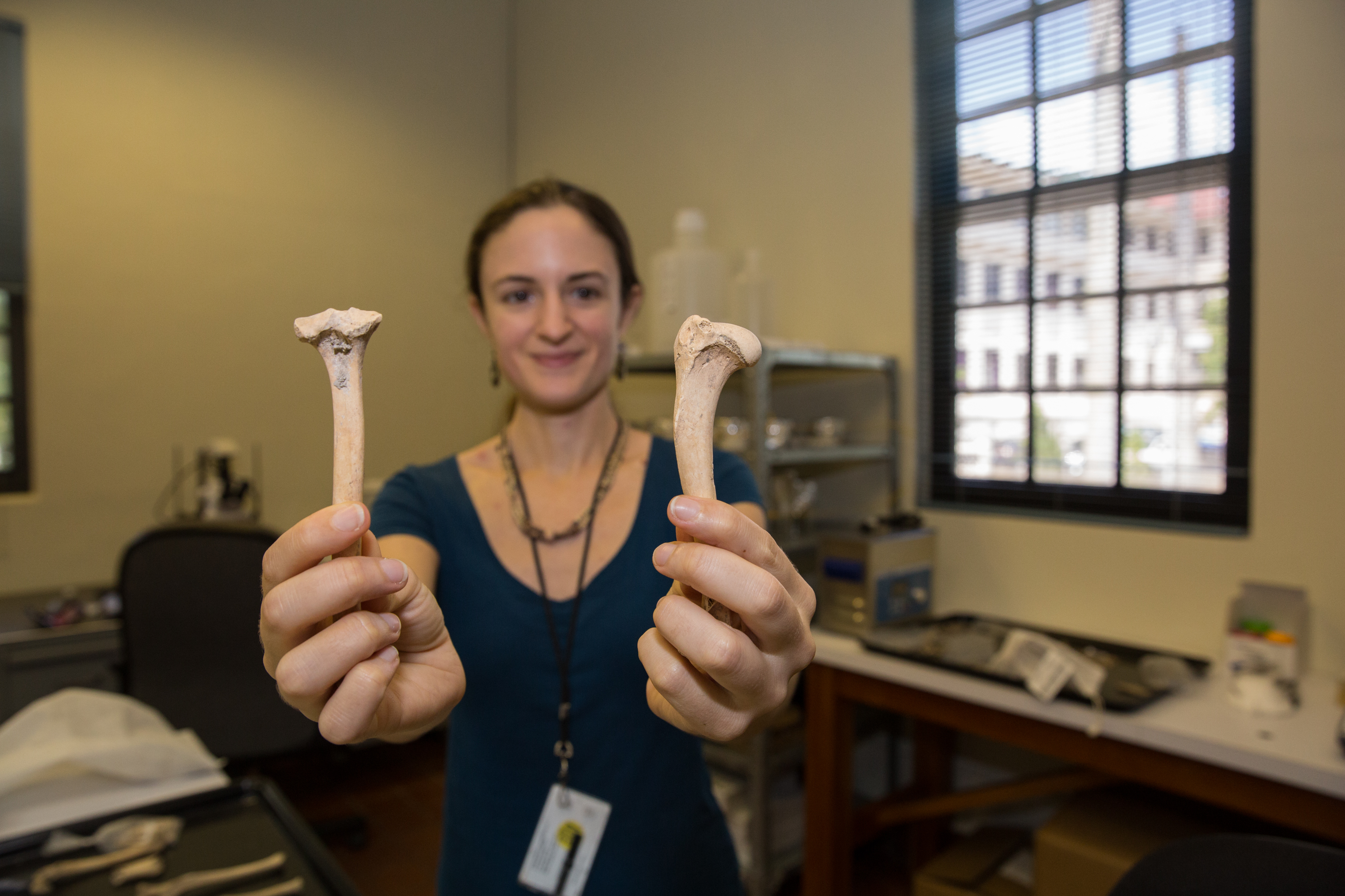 Scientist holding dog bones