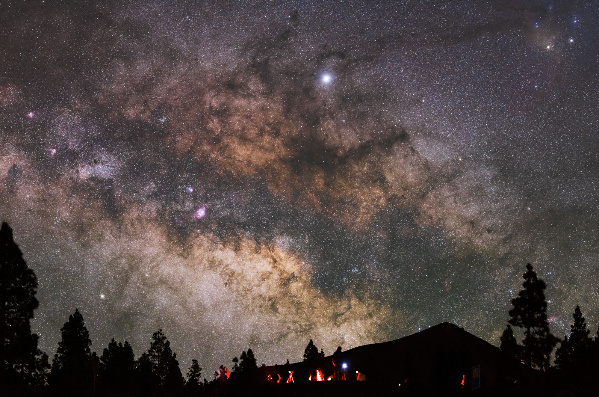 Night sky illuminated by bright stars and other celestial objects