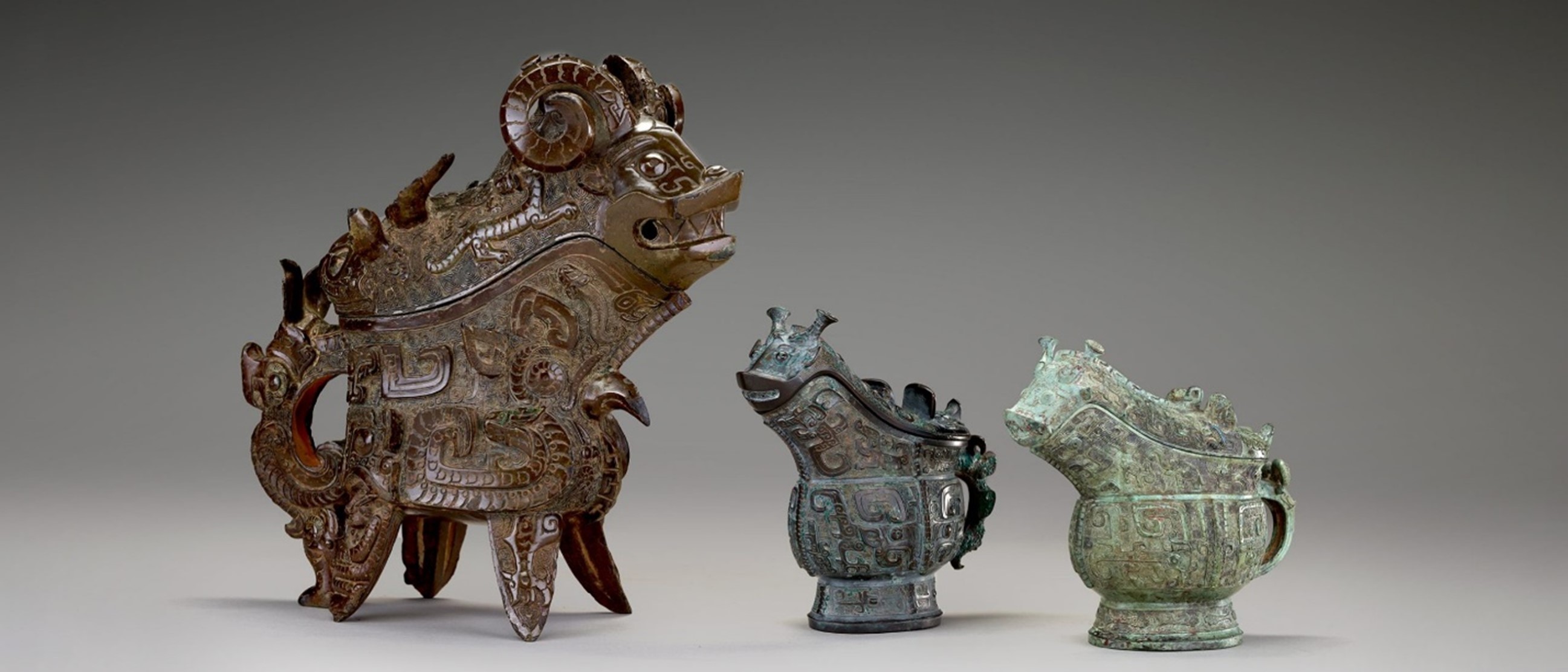 Three sculptural objects of varying ornateness depicting stylized animals