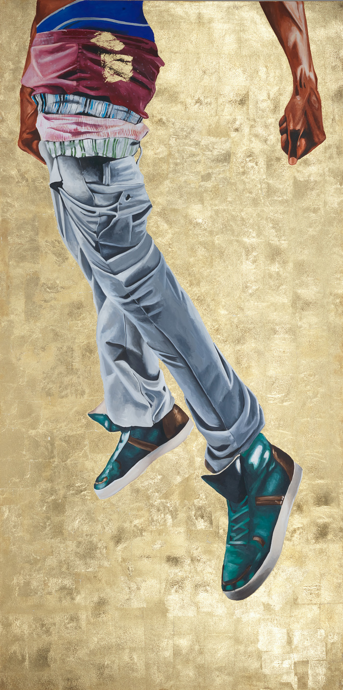 Painting of boys legs in jeans floating against gold background.