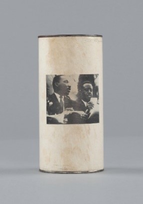 Photo of cylinder container with black and white photo printed on paper exterior.