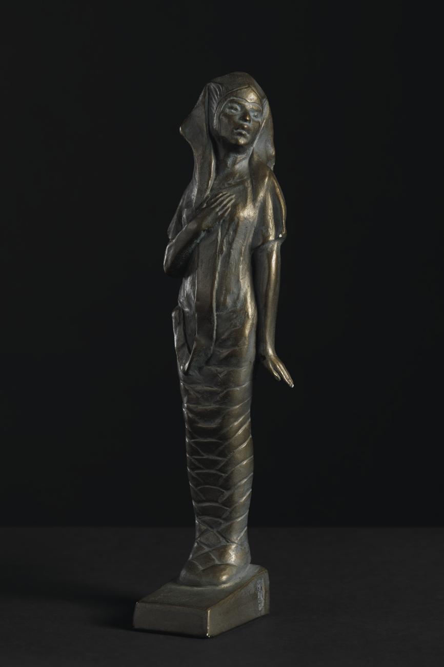 Sculpture of woman in Egyptian headdress and attire.