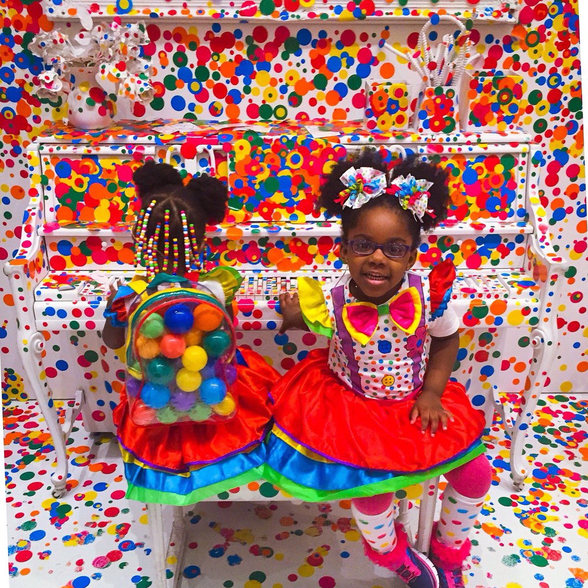 Two young girls in bright polka dot clothes in bright polka dot exhbition