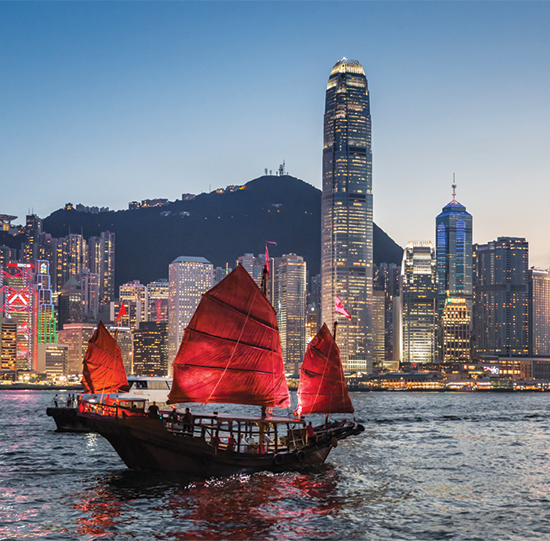 Traditional junk boat sailing in Victoria Harbour, Hong Kong