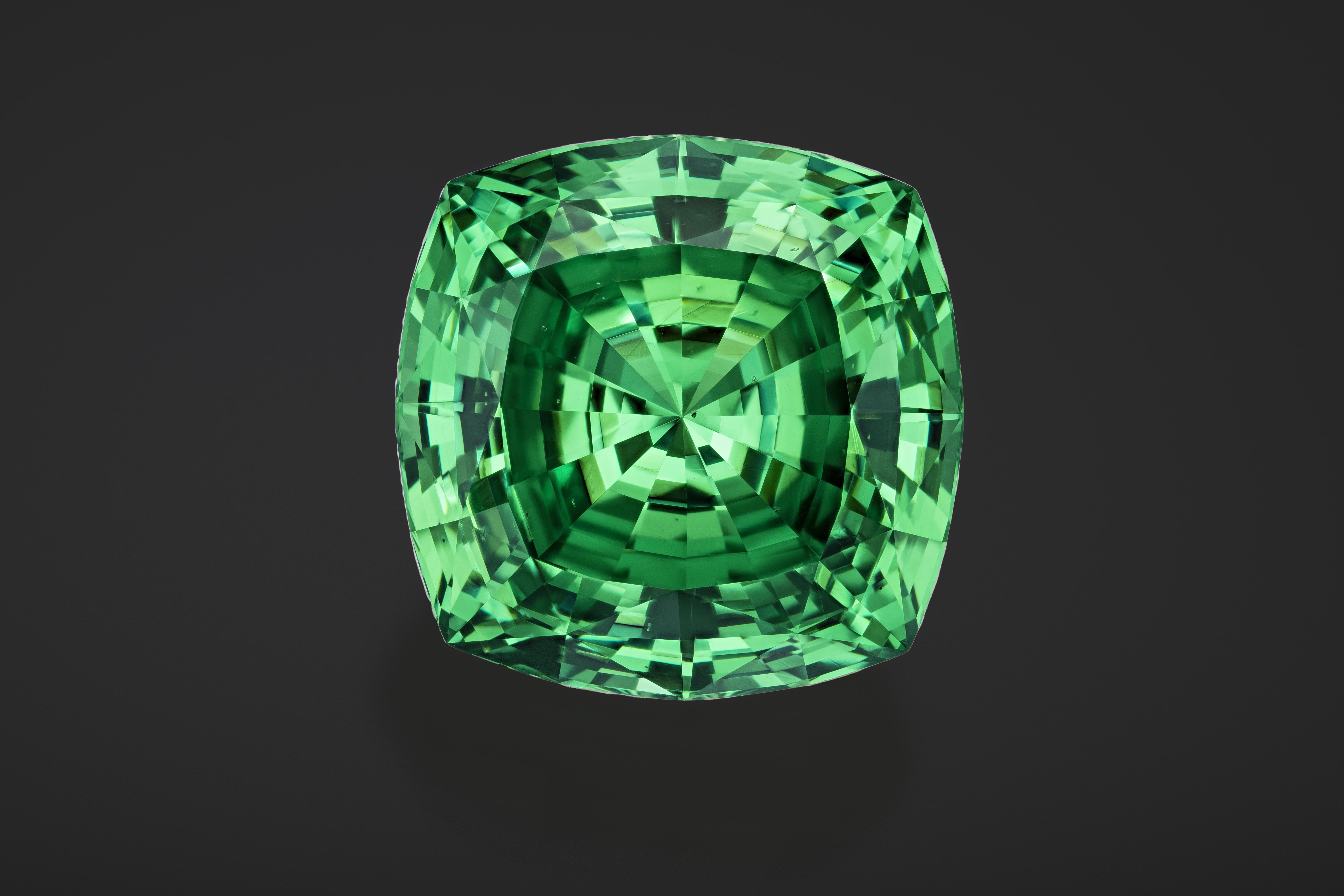 Large green gem on black background