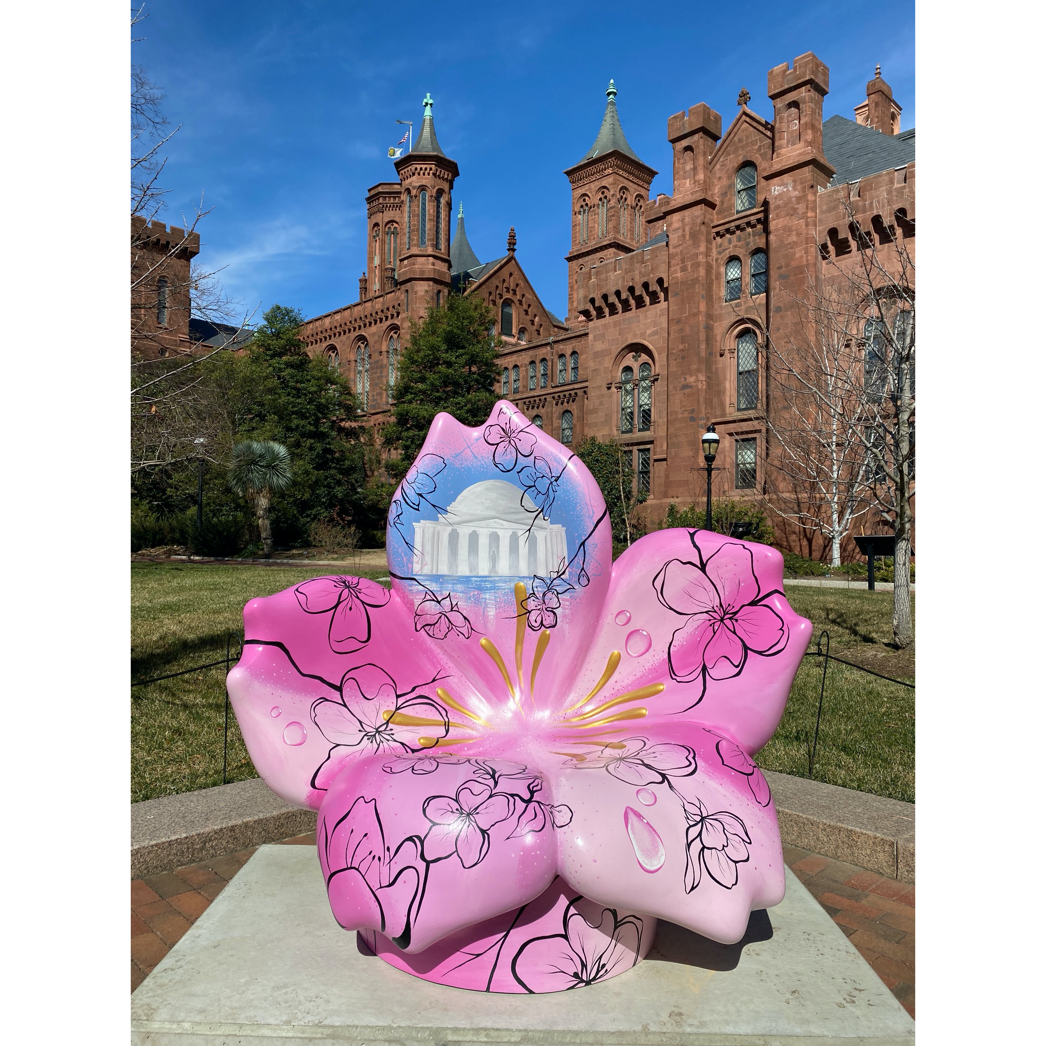 Sculpture shaped like cherry blossom sits in front of Smithsonian Castle