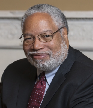 Secretary Lonnie Bunch sits at table