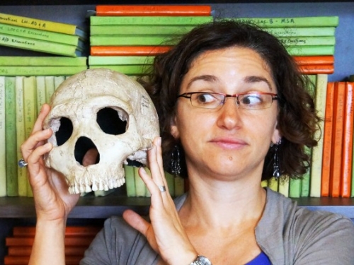 Briana Pobiner holding a skull.