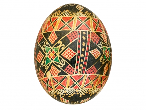Egg covered in a geometric design with red, yellow, black and green.