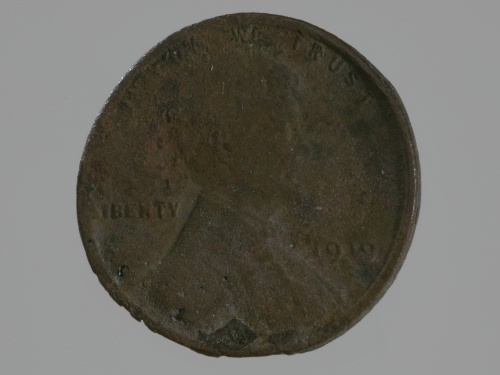 A 1919 penny. Its face is partially melted.
