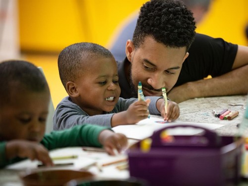 Parent and child creating art at the National Museum of African American History and Culture.