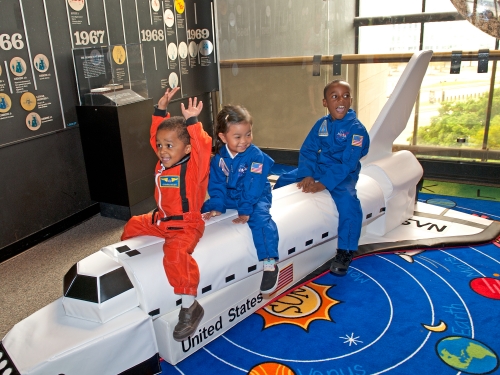 Children playing with model space shuttle