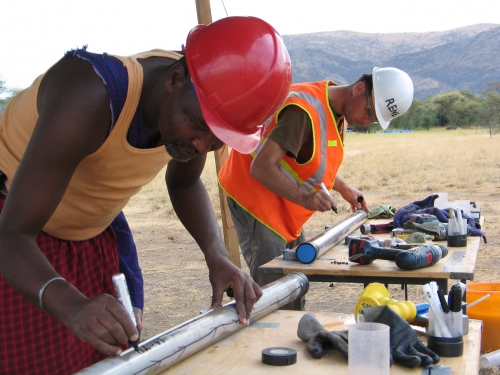 Workers examining the core sample in the field