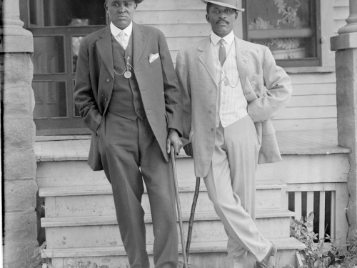 George W. Butcher and friend wearing suits and leaning on canes