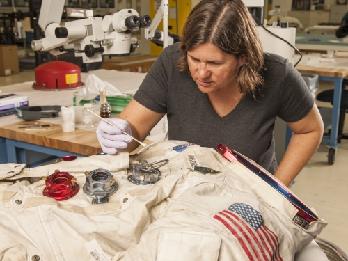 Conservator working on spacesuit
