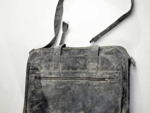 Battered black bag with shoulder strap
