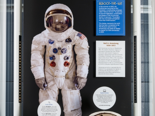 Exhibit case with spacesuit, helmet and gloves