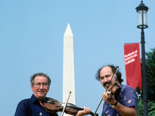Two musicians with Washington monument in background