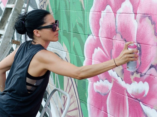 woman painting mural