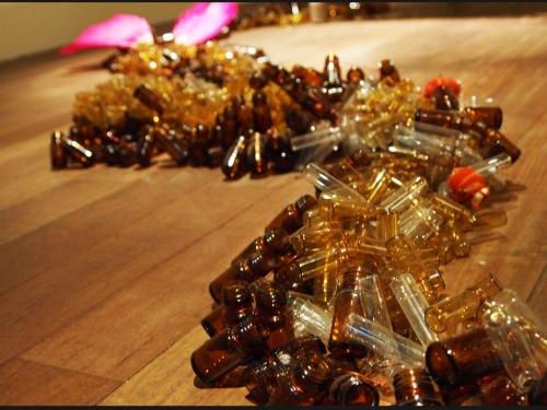 Rina Banerjee - Trail of glass bottles
