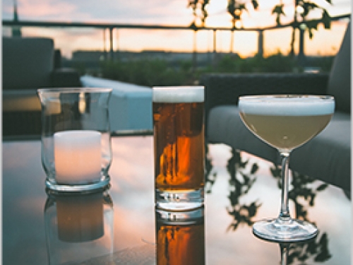 Cocktails on table with sunset in background