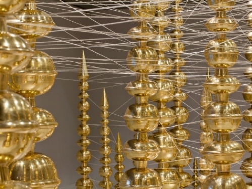 Detail of art installation featuring golden pots