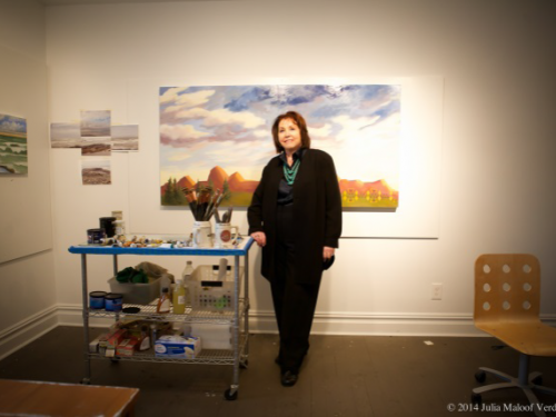 Artist in her studio in front of painting