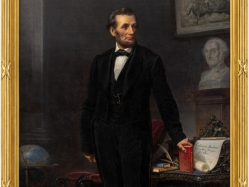 Oil painting of Abraham Lincoln standing next to a desk