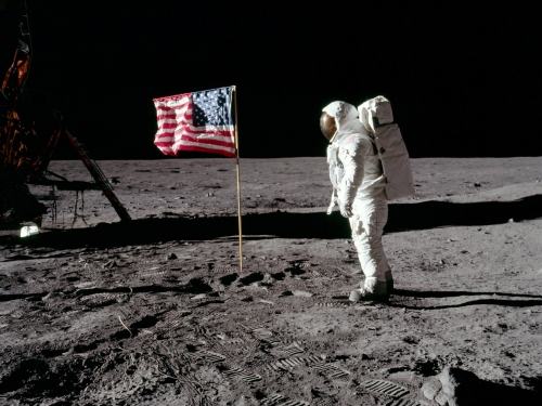 Neil Armstrong on surface of the moon with American flag