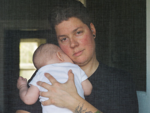 Person cradles baby on their chest