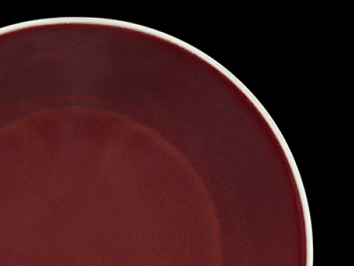 Close up of edge of red dish