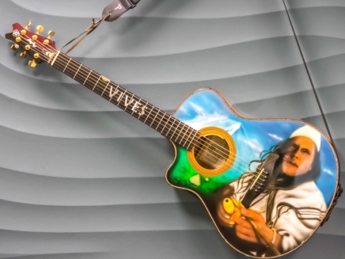 Guitar with airbrushed portrait of Carlos Vives