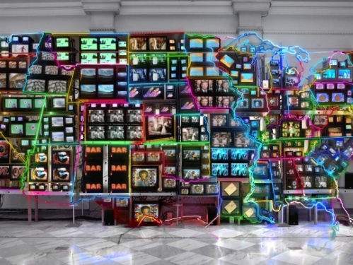 Neon sculpture of the United States composed of televisions