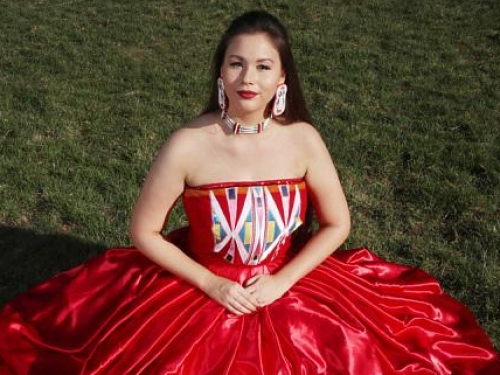Isabella Aiukli Cornell wears her prom dress and beaded jewelry.